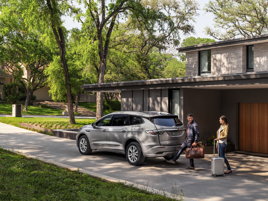 Family getting ready to load a Buick Enclave