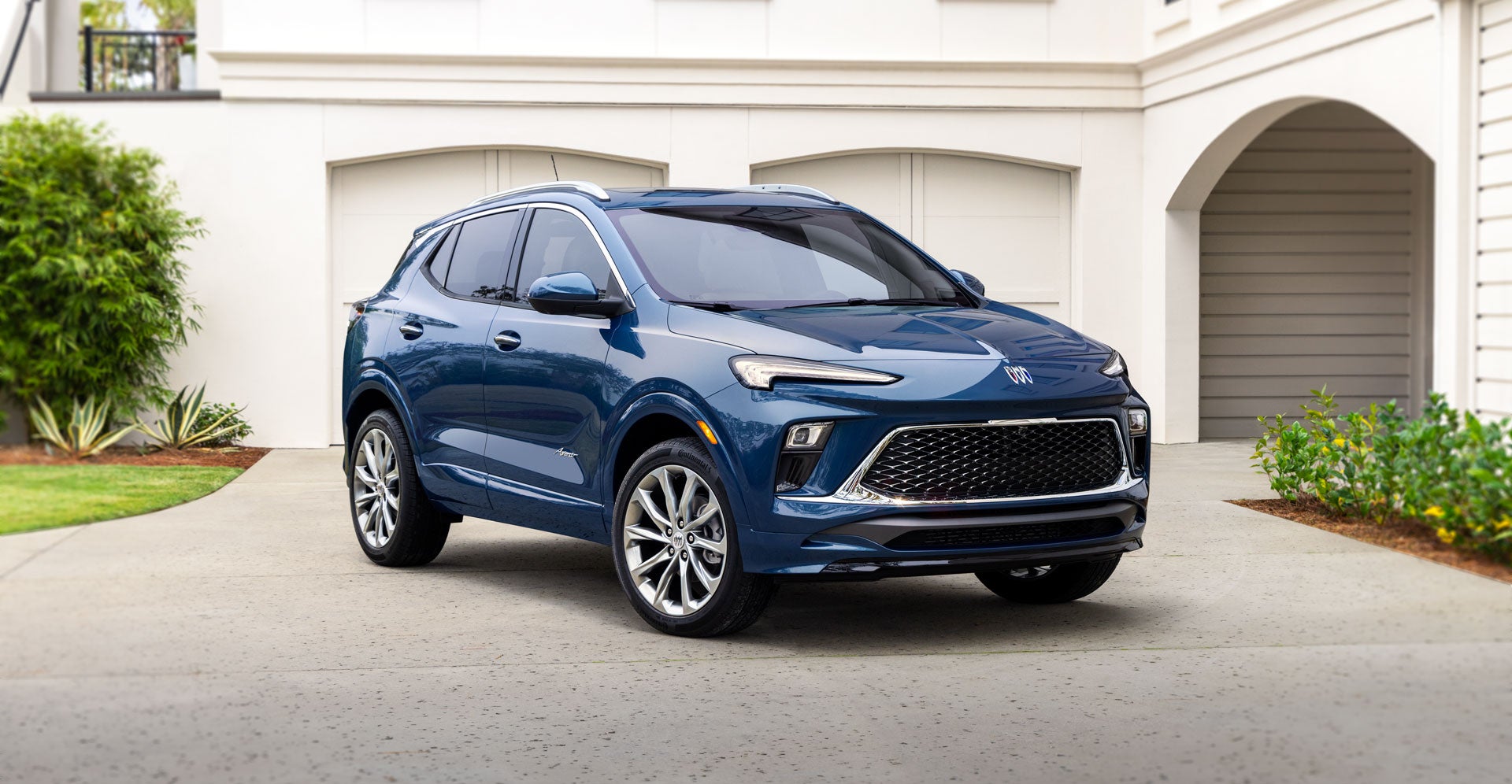The Buick Encore Avenir Parked in Front of a Luxurious Home