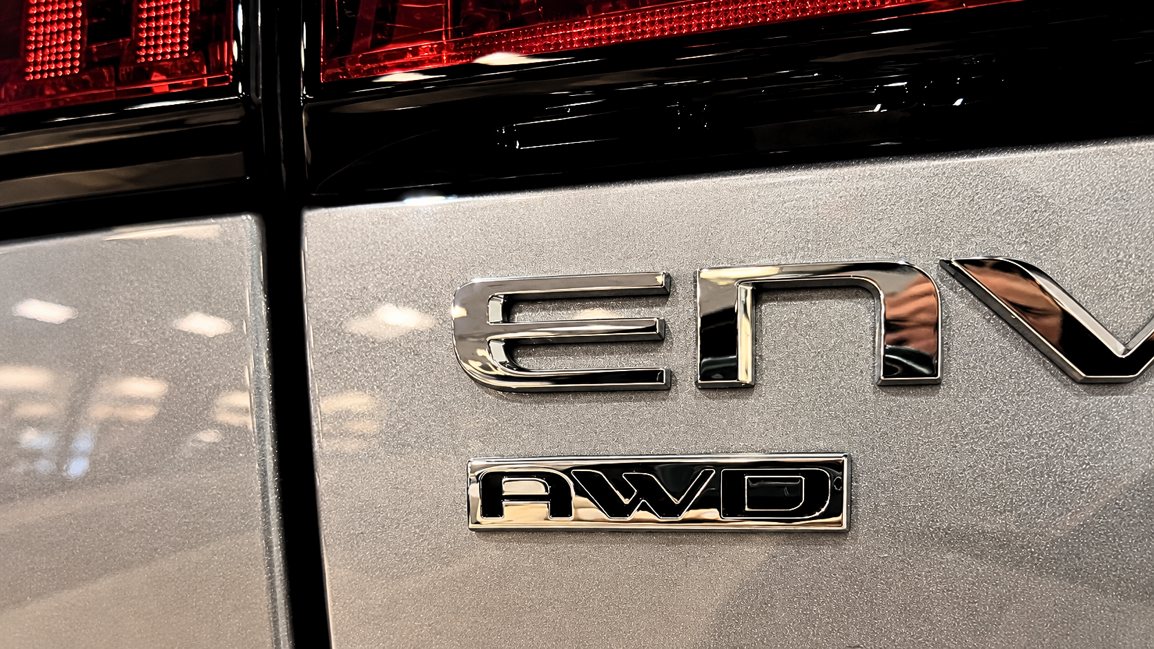 AWD badge on a Buick SUV at Arnie Bauer Buick GMC in Matteson, IL, highlighting all-wheel drive for Chicago driving conditions.