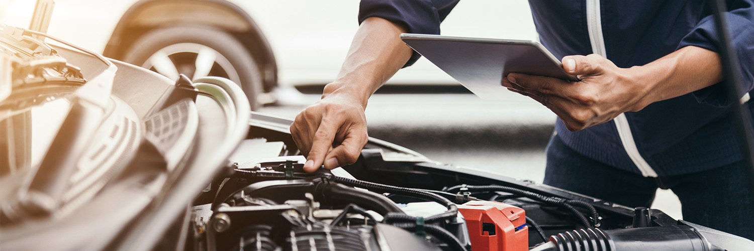 GM-certified technician servicing a GMC vehicle at Arnie Bauer Buick GMC near Homewood, IL